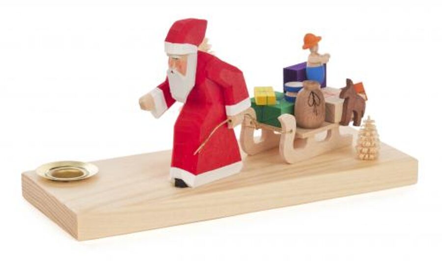 Père Noël avec son traineau de jouets et bougeoir